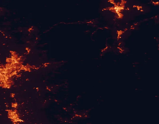 Satellite night-light map of the 100 km around Eldorado National Forest, with Reno, Stockton and Elk Grove marked