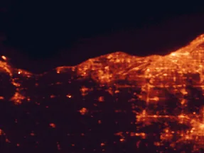 Satellite night-light map of the 50 km around Elyria, with Cleveland, Lorain and Parma marked